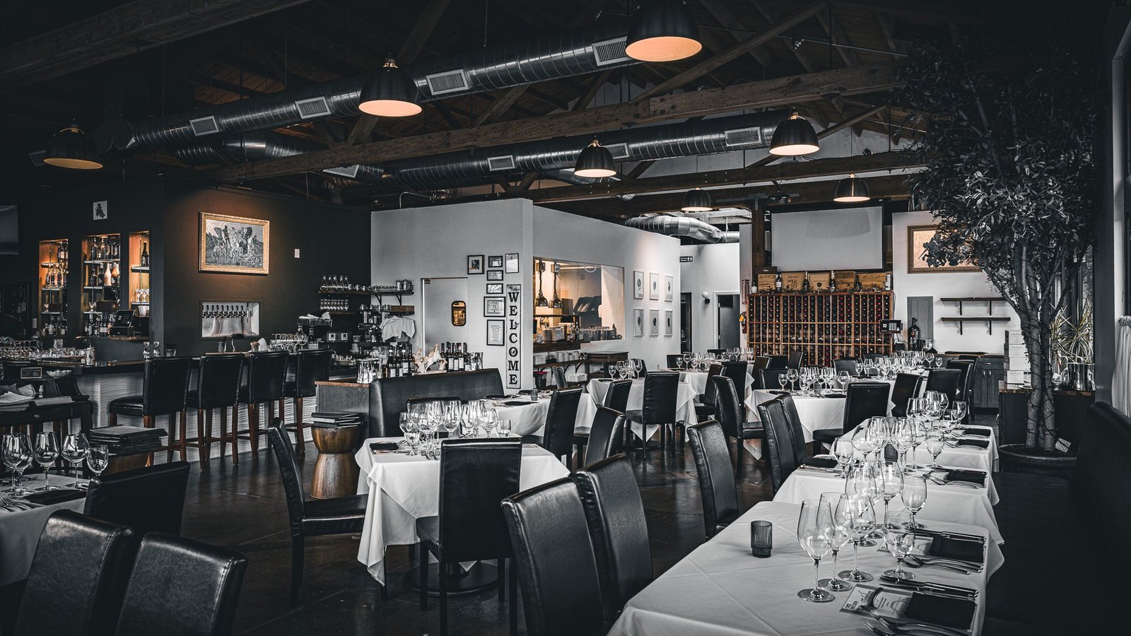 Chez Bacchus dining room with exposed beams and white linen tables